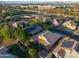 An aerial view shows a well-maintained home with solar panels, mature trees, and lush landscaping at 2434 S Colleen Sw --, Mesa, AZ 85210