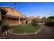 Private backyard with manicured lawn, stone pathway and a covered patio at 2434 S Colleen Sw --, Mesa, AZ 85210