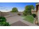 Manicured backyard featuring green lawn, mature landscaping, and paved patio at 2434 S Colleen Sw --, Mesa, AZ 85210