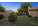 Well-maintained backyard featuring green grass, colorful foliage, and a block fence at 2434 S Colleen Sw --, Mesa, AZ 85210