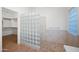 Bathroom with glass block wall, and a shower with mosaic-tiled floor at 2434 S Colleen Sw --, Mesa, AZ 85210