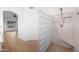 Bathroom featuring glass block wall, shower with mosaic tiled floors, and a doorway to another room at 2434 S Colleen Sw --, Mesa, AZ 85210