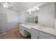 Bright bathroom featuring dual sinks, glass block accents, and a spacious walk-in shower at 2434 S Colleen Sw --, Mesa, AZ 85210