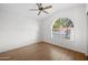 Bedroom with vaulted ceiling, laminate floors, ceiling fan, and arched window at 2434 S Colleen Sw --, Mesa, AZ 85210