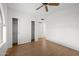 Bedroom featuring laminate flooring, ceiling fan, closet with sliding doors and large window at 2434 S Colleen Sw --, Mesa, AZ 85210