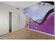 Bedroom featuring laminate floors, ceiling fan, closet with sliding doors and mural at 2434 S Colleen Sw --, Mesa, AZ 85210