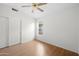 Bedroom with laminate flooring, ceiling fan and closet with sliding doors at 2434 S Colleen Sw --, Mesa, AZ 85210