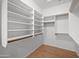 Walk-in closet featuring shelving, and laminate flooring at 2434 S Colleen Sw --, Mesa, AZ 85210