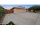 Spacious driveway leading to a three-car garage, complemented by a secure gated area on the side at 2434 S Colleen Sw --, Mesa, AZ 85210