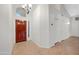 Elegant foyer with a beautiful wood front door, a stylish light fixture, and neutral tile flooring at 2434 S Colleen Sw --, Mesa, AZ 85210
