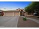 Inviting front exterior of a home showcasing a three-car garage and a meticulously landscaped yard at 2434 S Colleen Sw --, Mesa, AZ 85210