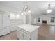 Bright kitchen features white cabinets, an island, pendant lighting, and stainless steel refrigerator at 2434 S Colleen Sw --, Mesa, AZ 85210