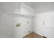 Clean, well-lit laundry room featuring overhead storage and convenient utility connections at 2434 S Colleen Sw --, Mesa, AZ 85210