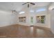 Sunlit living room with tile flooring, modern ceiling fans, and multiple windows overlooking the backyard at 2434 S Colleen Sw --, Mesa, AZ 85210