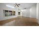 Open-concept living area filled with natural light, showcasing tile floors, ceiling fans, and large windows at 2434 S Colleen Sw --, Mesa, AZ 85210