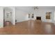 An empty living room featuring large windows, a ceiling fan and a cozy fireplace at 2434 S Colleen Sw --, Mesa, AZ 85210