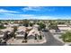 Aerial view of a neighborhood, showcasing well-maintained homes, tree-lined streets, and stunning mountain views at 254 W Amoroso Dr, Gilbert, AZ 85233