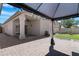 Charming covered patio with cozy outdoor seating, lush landscaping, and privacy in the backyard at 254 W Amoroso Dr, Gilbert, AZ 85233