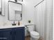 Cozy bathroom with blue vanity, white walls, and modern mirror at 254 W Amoroso Dr, Gilbert, AZ 85233