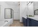 Full bathroom featuring a tub, shower, double sinks, quartz countertops and tiled flooring at 254 W Amoroso Dr, Gilbert, AZ 85233
