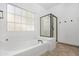 Bright bathroom featuring a tub, shower and a large window for natural light at 254 W Amoroso Dr, Gilbert, AZ 85233