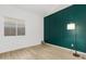 Bedroom featuring wood floors, a decorative wall, and a large window for natural light at 254 W Amoroso Dr, Gilbert, AZ 85233