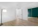 Bedroom with light wood flooring, a modern lamp and ensuite bathroom at 254 W Amoroso Dr, Gilbert, AZ 85233