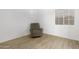 Bedroom with a neutral palette, wood floors and comfortable reclining chair at 254 W Amoroso Dr, Gilbert, AZ 85233