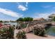 Beautiful walking bridge at lakeside park with desert landscaping and mature trees at 254 W Amoroso Dr, Gilbert, AZ 85233