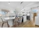 Bright kitchen featuring stainless appliances, white cabinets, blue island, and a dining area at 254 W Amoroso Dr, Gilbert, AZ 85233