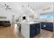 Bright, open kitchen featuring a large island, blue cabinets, stainless appliances, and eat-in dining area at 254 W Amoroso Dr, Gilbert, AZ 85233
