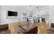 Open-concept living space featuring built in bookshelves and a kitchen with modern white cabinets and a center island at 254 W Amoroso Dr, Gilbert, AZ 85233