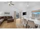 Bright living room with hardwood floors, a sliding glass door to the backyard and a dining table at 254 W Amoroso Dr, Gilbert, AZ 85233