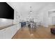 Open-concept living space featuring built in bookshelves and a kitchen with modern white cabinets and a center island at 254 W Amoroso Dr, Gilbert, AZ 85233