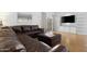 Cozy living room with leather sofa, built in cabinets, a sliding glass door to the patio and hardwood floors at 254 W Amoroso Dr, Gilbert, AZ 85233