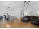 Spacious living room with hardwood floors, recessed lighting, ceiling fan, and open access to kitchen at 254 W Amoroso Dr, Gilbert, AZ 85233