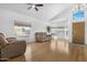 Open living room with wood floors, vaulted ceiling, and lots of natural light at 254 W Amoroso Dr, Gilbert, AZ 85233