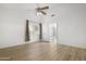 Bright main bedroom with wood flooring, a ceiling fan, and an ensuite bathroom with a shower at 254 W Amoroso Dr, Gilbert, AZ 85233