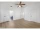 Spacious main bedroom with light wood flooring, ceiling fan, and ensuite bathroom at 254 W Amoroso Dr, Gilbert, AZ 85233