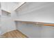 Ample shelving and hanging space in this walk-in closet with light wood floors at 254 W Amoroso Dr, Gilbert, AZ 85233