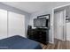 Comfortable bedroom featuring a dresser with mounted television and a closet for ample storage at 2650 W Union Hills Dr # 164, Phoenix, AZ 85027