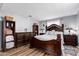 Bedroom displaying matching dark wood furniture, wood-look floors, and ample storage solutions at 2650 W Union Hills Dr # 164, Phoenix, AZ 85027