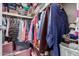 A walk-in closet is fully stocked with a large assortment of folded and hung clothing, totes, and shoe boxes at 2650 W Union Hills Dr # 164, Phoenix, AZ 85027