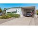 Single-story home with covered parking; tidy landscaping with flowers and gravel at 2650 W Union Hills Dr # 164, Phoenix, AZ 85027