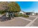 Landscaped front yard with mature tree offering shade in this mobile home community at 2650 W Union Hills Dr # 164, Phoenix, AZ 85027