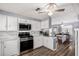 Updated kitchen with gas range, white cabinets and adjacent dining area at 2650 W Union Hills Dr # 164, Phoenix, AZ 85027