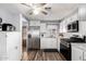 A well-appointed kitchen featuring white cabinetry, stainless steel appliances, and hardwood floors at 2650 W Union Hills Dr # 164, Phoenix, AZ 85027