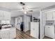 Open kitchen view with updated flooring, ceiling fan, dining area and laundry at 2650 W Union Hills Dr # 164, Phoenix, AZ 85027