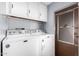 Laundry area featuring a washer, dryer, and storage cabinets at 2650 W Union Hills Dr # 164, Phoenix, AZ 85027