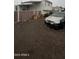Compact home, including a gravel yard, privacy fence, and space for parking at 2721 E Beverly Ln, Phoenix, AZ 85032